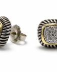 Pair of silver and gold earrings with diamond-like stones on a white background