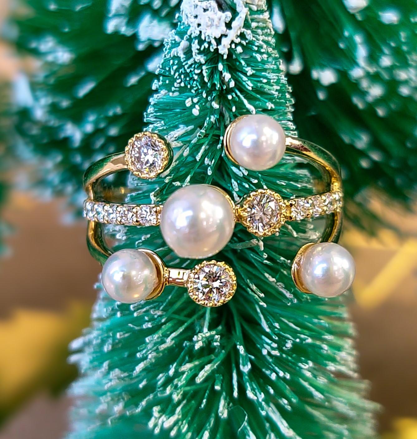 Gold diamond and pearl ring on a decorated Christmas tree