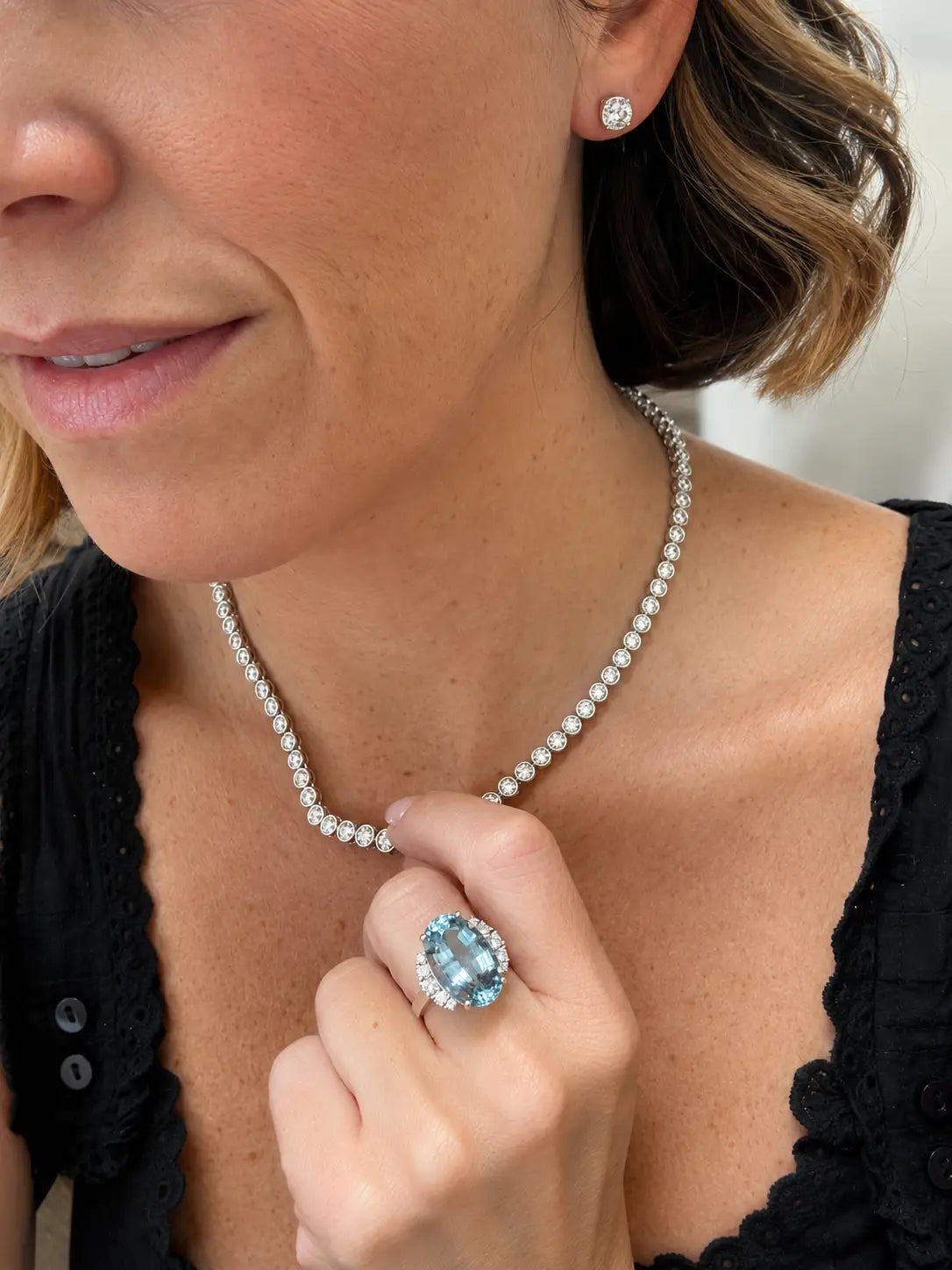 women wearing diamond necklace, earrings and ring