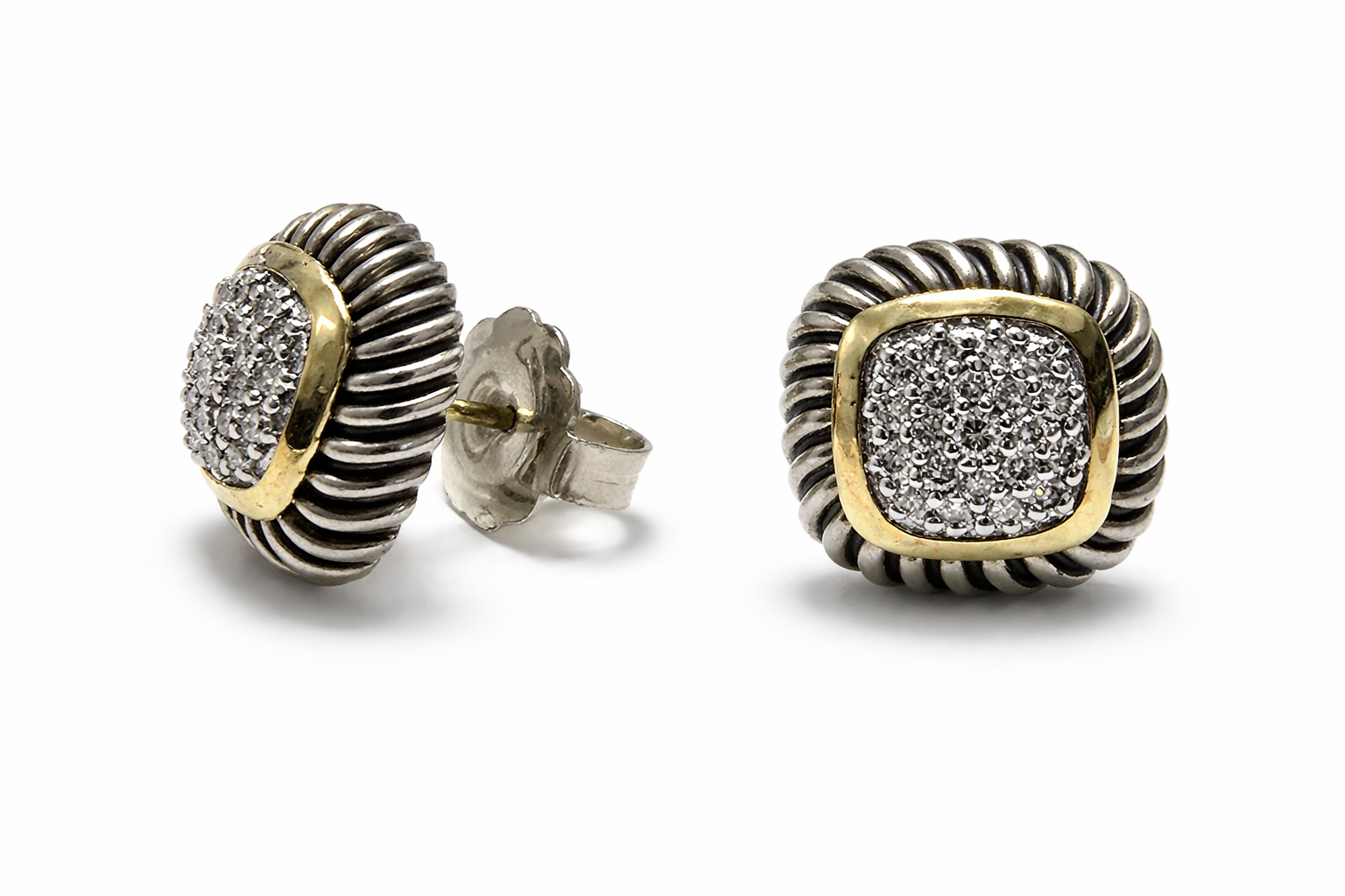 Pair of silver and gold earrings with diamond-like stones on a white background