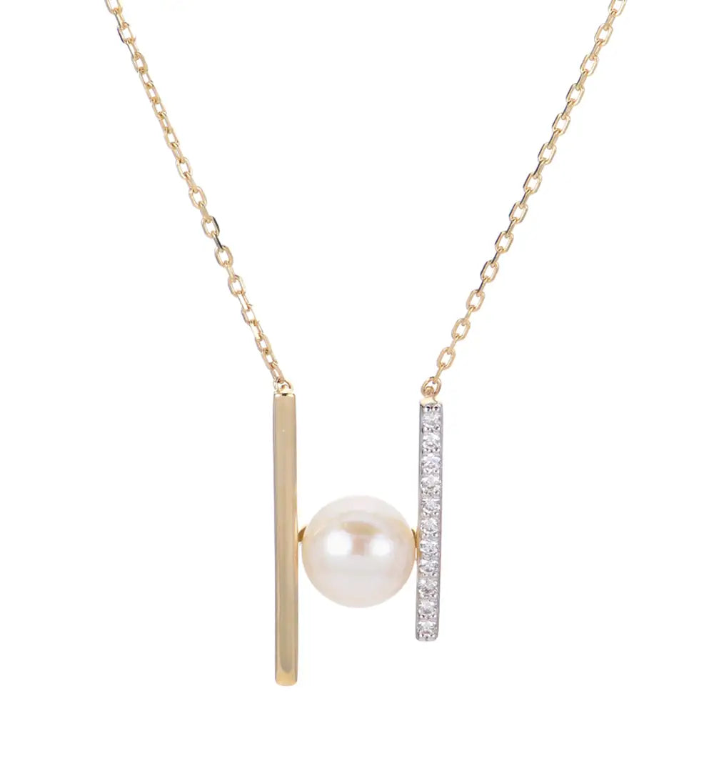 Gold necklace with a pearl pendant and diamond accents on a white background