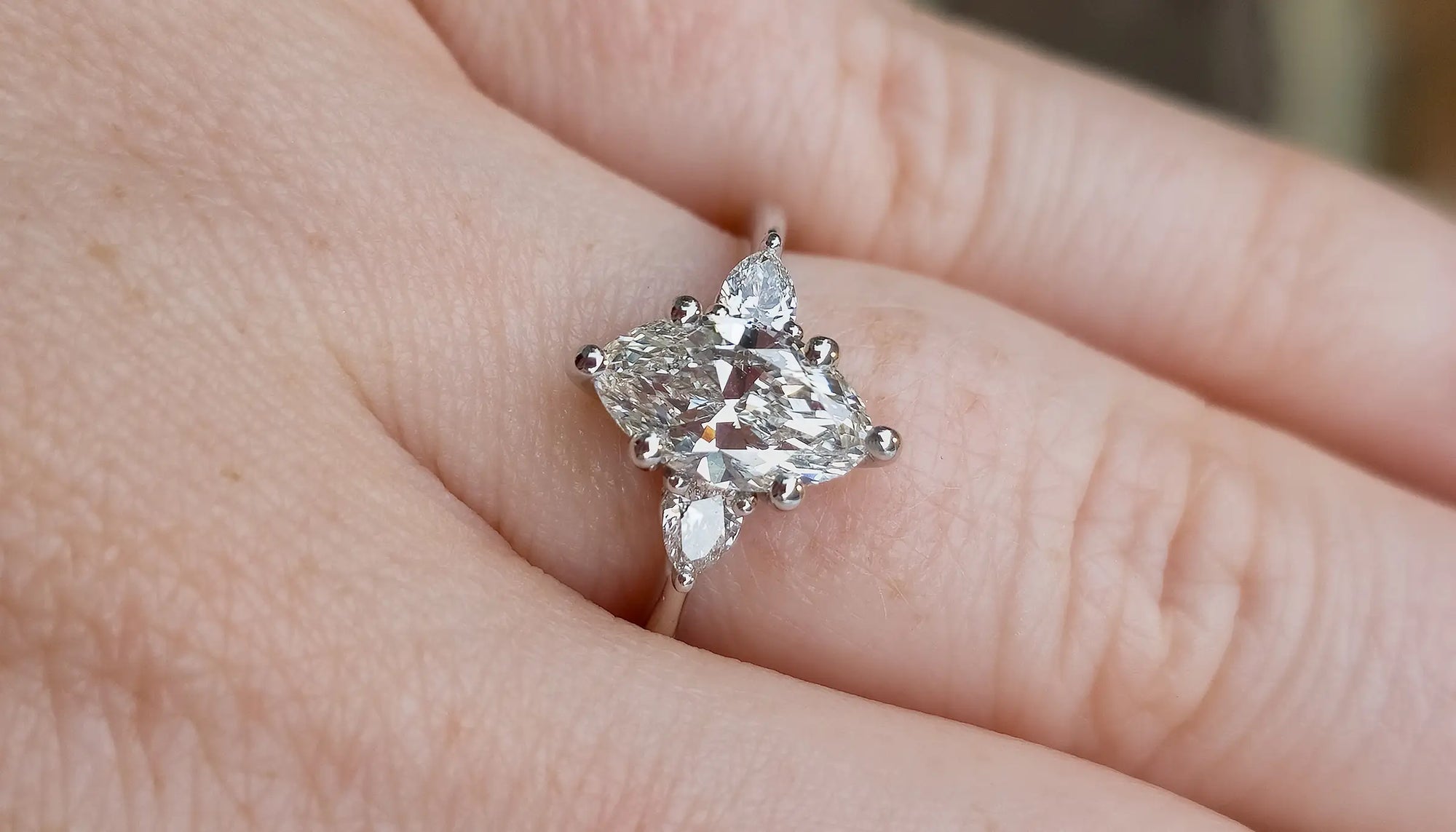 marquise diamond ring with triangle side stones on each side  